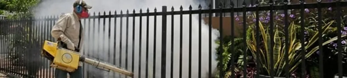 Mosquito control technician fogging a yard perimeter for mosquito reduction in Richmond, VA